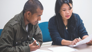 Two people discussing a paper