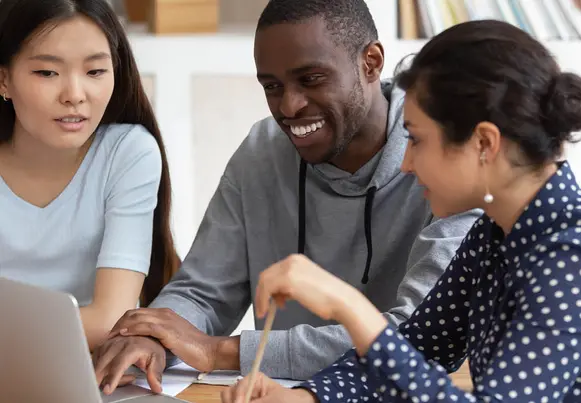 Multicultural students collaborate in the library