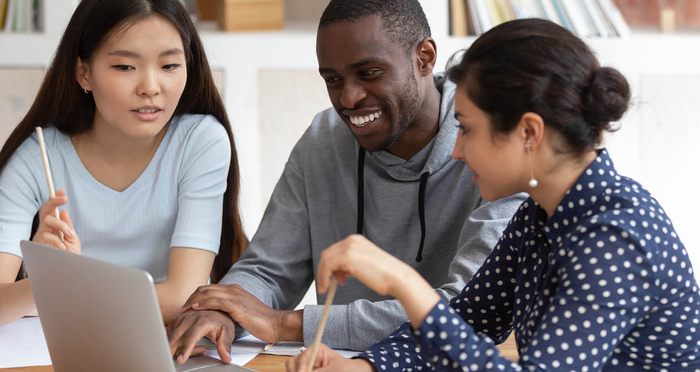 Multicultural students collaborate in the library