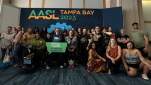 AASL Photo Booth in Tampa with a posed group of more than 30 members. smiling for the camera.